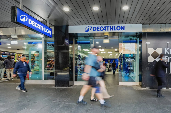 decathlon store front with civilians walking past