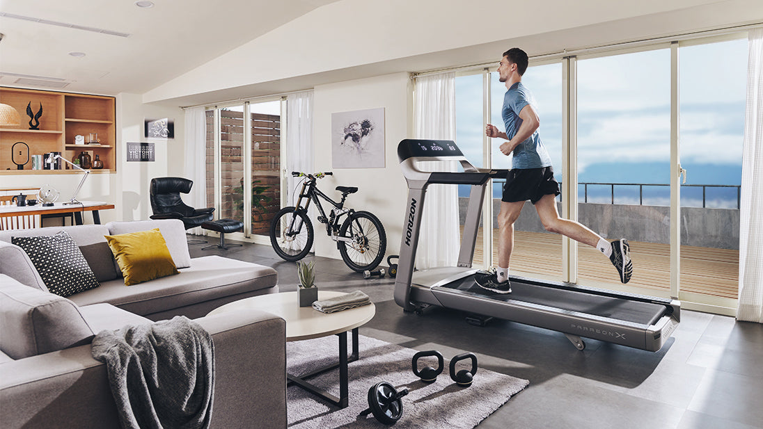 horizon paragon x male running treadmill indoor living room