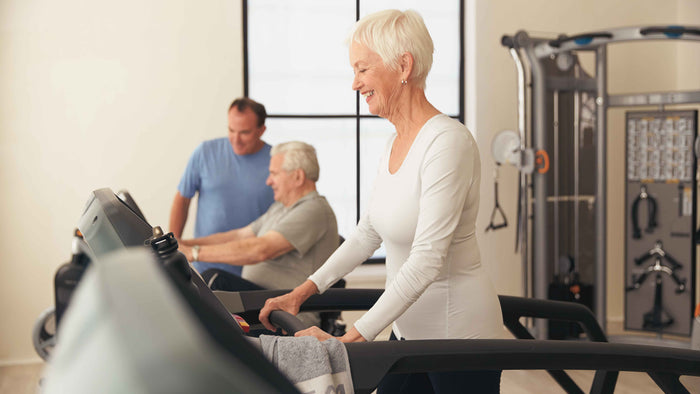 female walking on treadmill - mature lifestyle