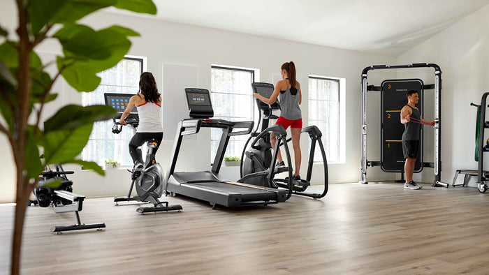 male and females using matrix elliptical, connexus, upright cycle - indoor gym setting