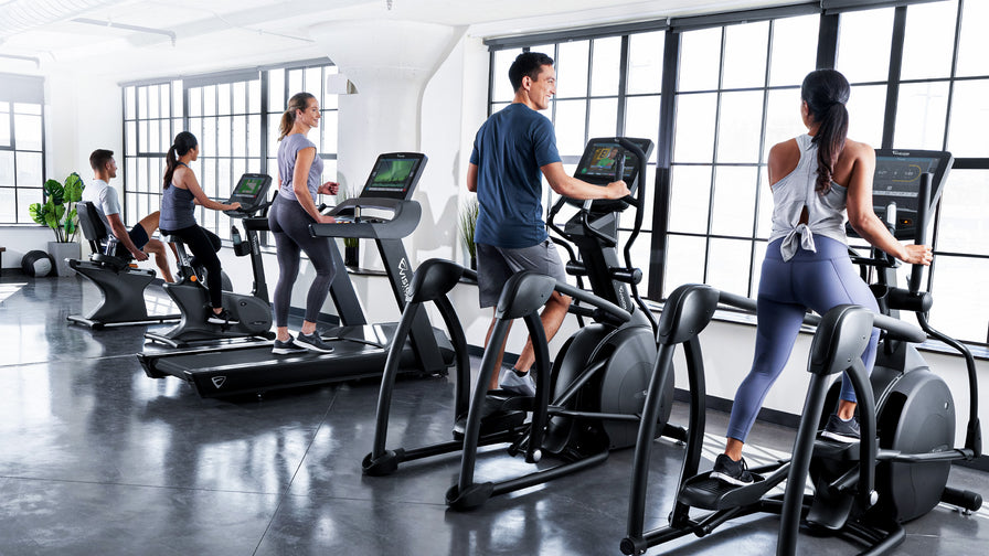 vision fitness lifestyle male female working out elliptical