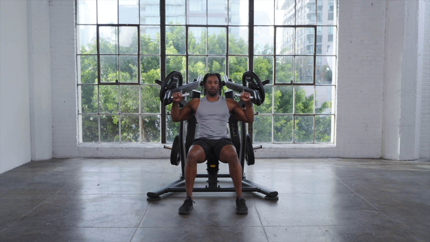 Man using Plate Loaded Movement Lifestyle Image Shoulder Press in open space