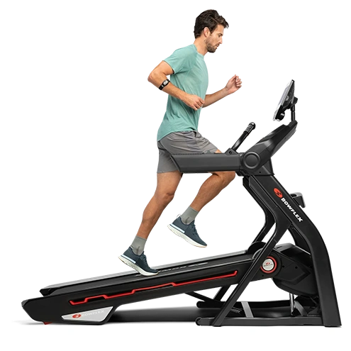 male in green tshirt running bowflex treadmill incline png
