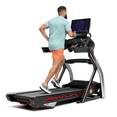 man in blue tshirt running on bowflex treadmill png