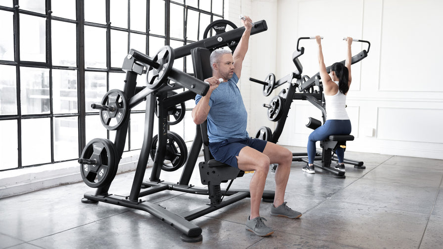 vision strength plate loaded landing page - featuring male and female using lat pulldown and raise