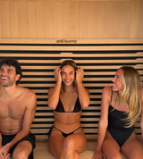 3 people sitting inside chill bunny indoor sauna - smiling 